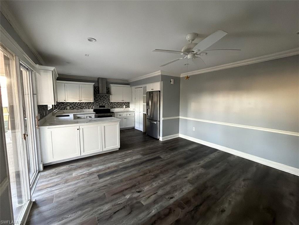 a kitchen with a refrigerator stove top oven and cabinets