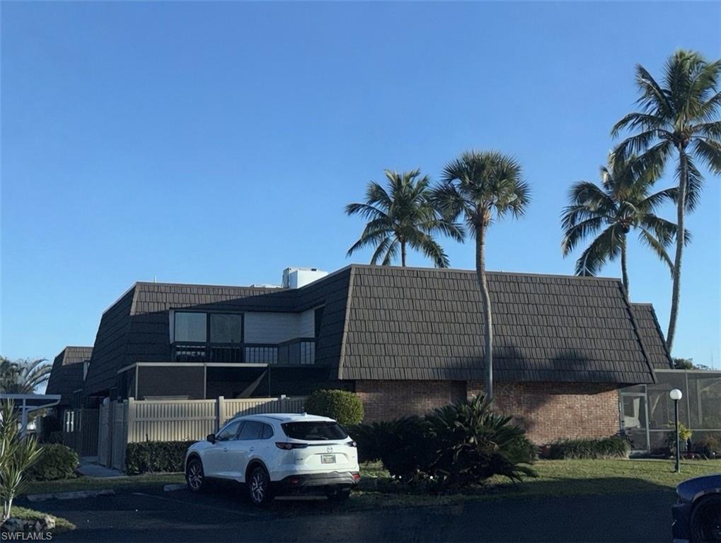 160 Lake Point Lane, Unit 6D Naples, FL 34112 - Photo 13 of 14 a car parked in front of house
