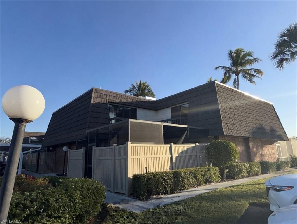 160 Lake Point Lane, Unit 6D Naples, FL 34112 - Photo 14 of 14 a front view of a house with a yard
