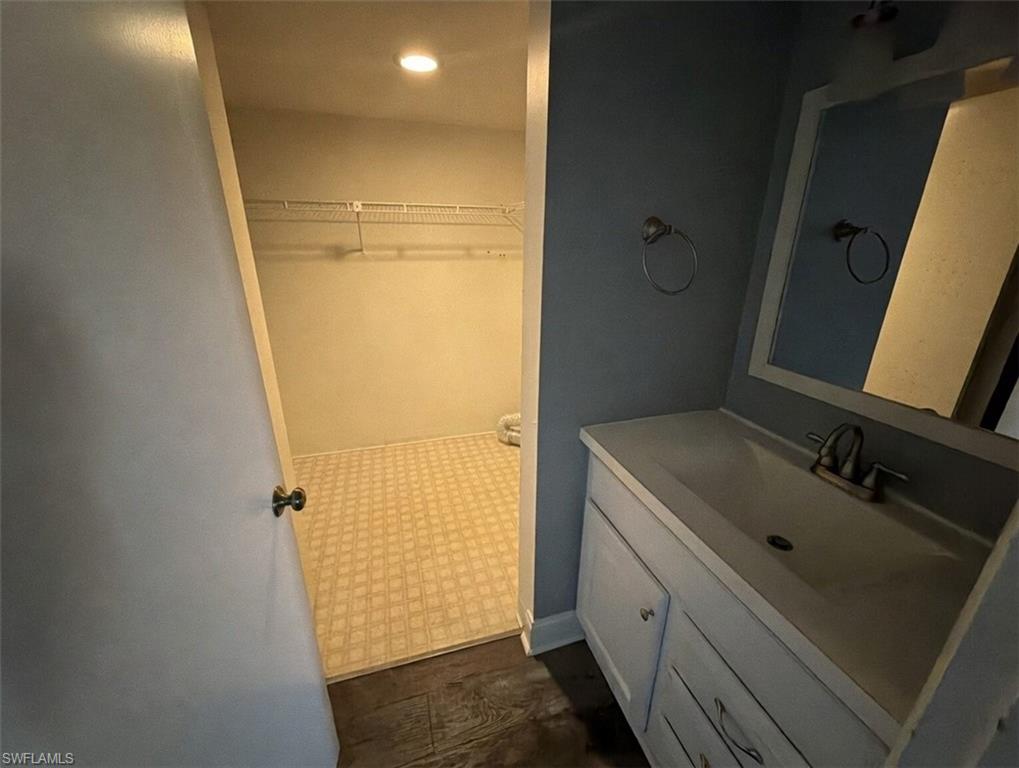 160 Lake Point Lane, Unit 6D Naples, FL 34112 - Photo 5 of 14 a bathroom with a sink and mirror