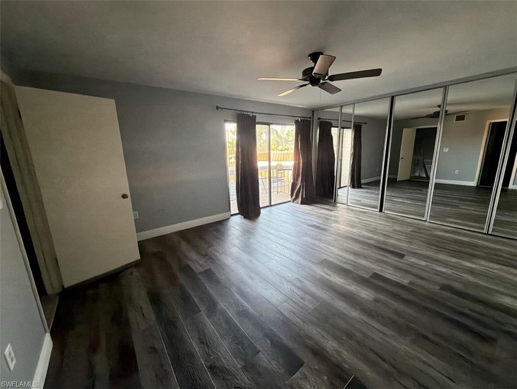 160 Lake Point Lane, Unit 6D Naples, FL 34112 - Photo 6 of 14 wooden floor in an empty room with a window