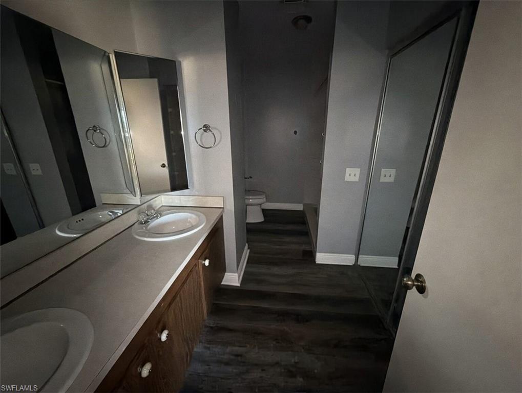 160 Lake Point Lane, Unit 6D Naples, FL 34112 - Photo 7 of 14 a bathroom with a sink a mirror and a toilet