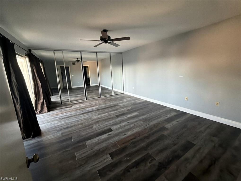 160 Lake Point Lane, Unit 6D Naples, FL 34112 - Photo 8 of 14 wooden floor in an empty room