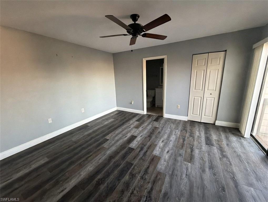 160 Lake Point Lane, Unit 6D Naples, FL 34112 - Photo 9 of 14 wooden floor in an empty room with a window