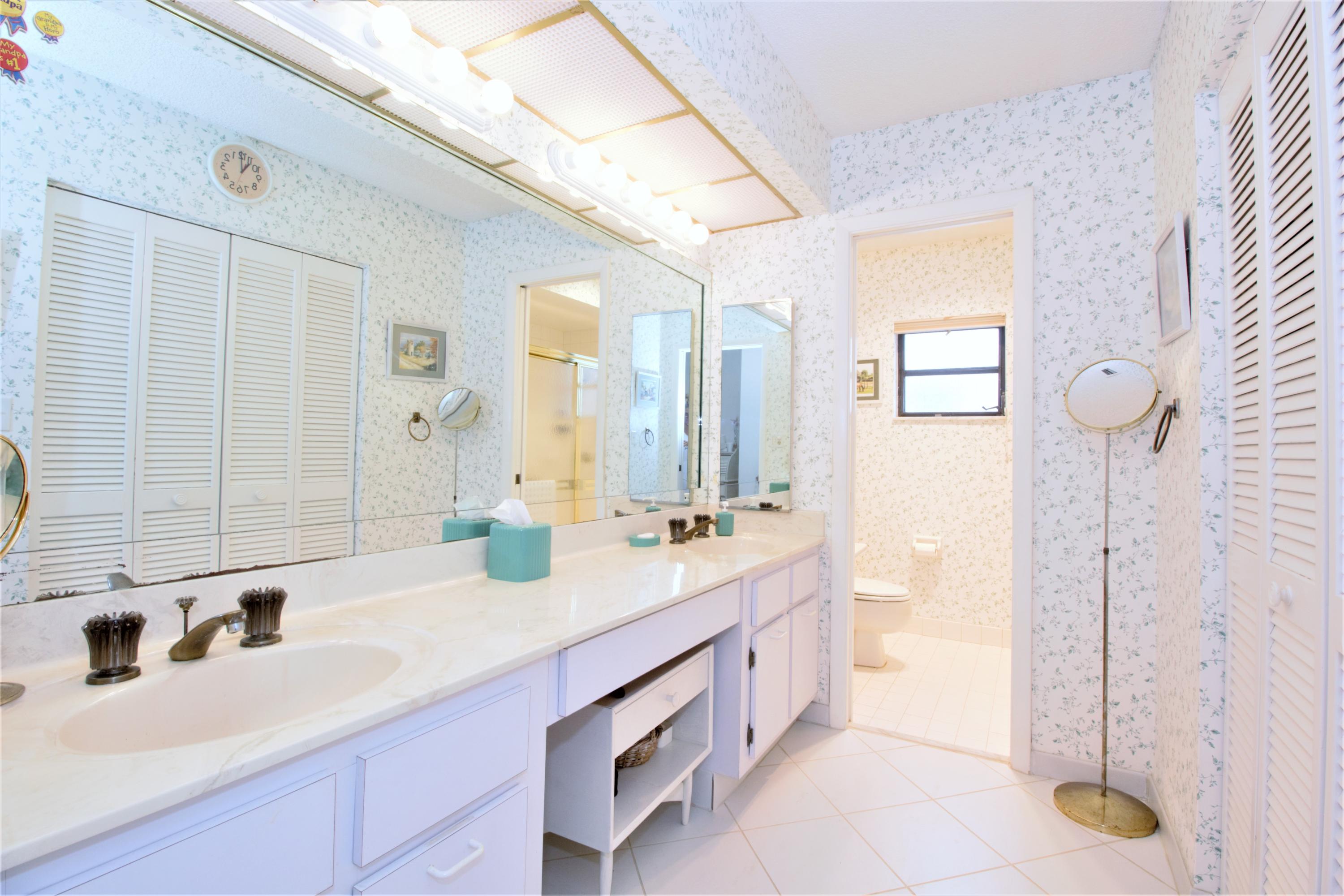 7751 Cloverfield Circle Boca Raton, FL 33433 - Photo 16 of 26 a bathroom with a double vanity sink mirror and double