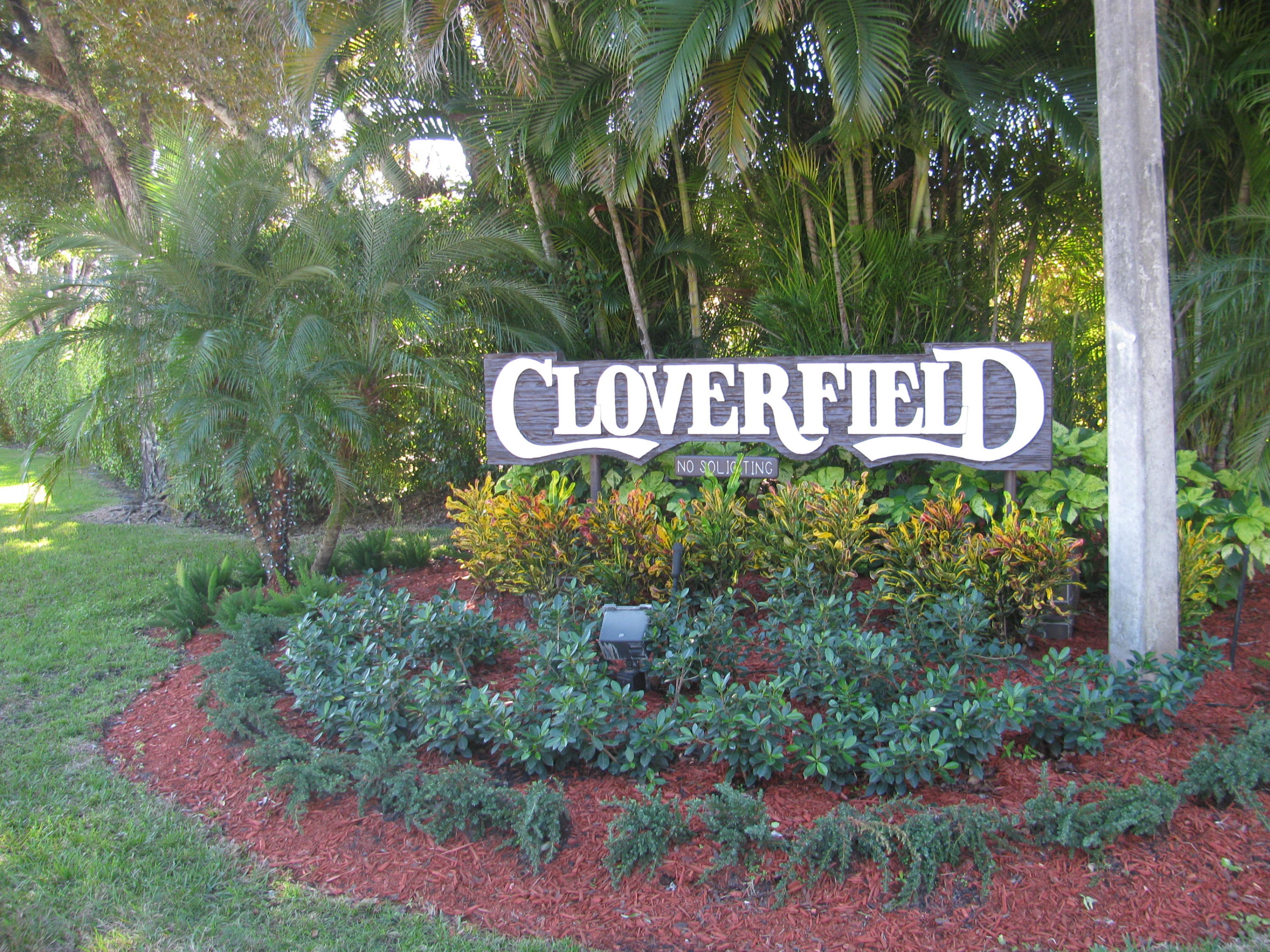 7751 Cloverfield Circle Boca Raton, FL 33433 - Photo 25 of 26 a sign that is sitting in front of flowers