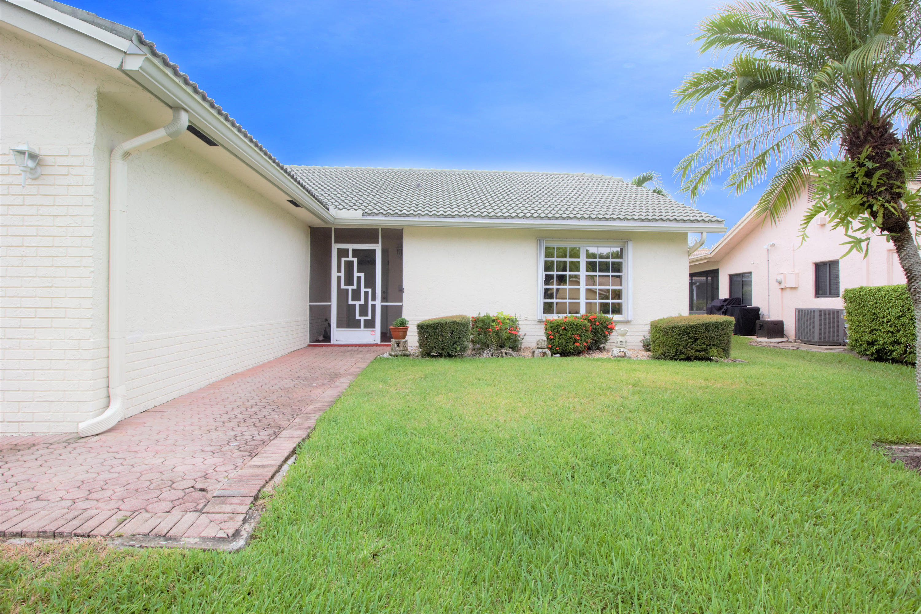 7751 Cloverfield Circle Boca Raton, FL 33433 - Photo 4 of 26 a view of a house with backyard and a tree