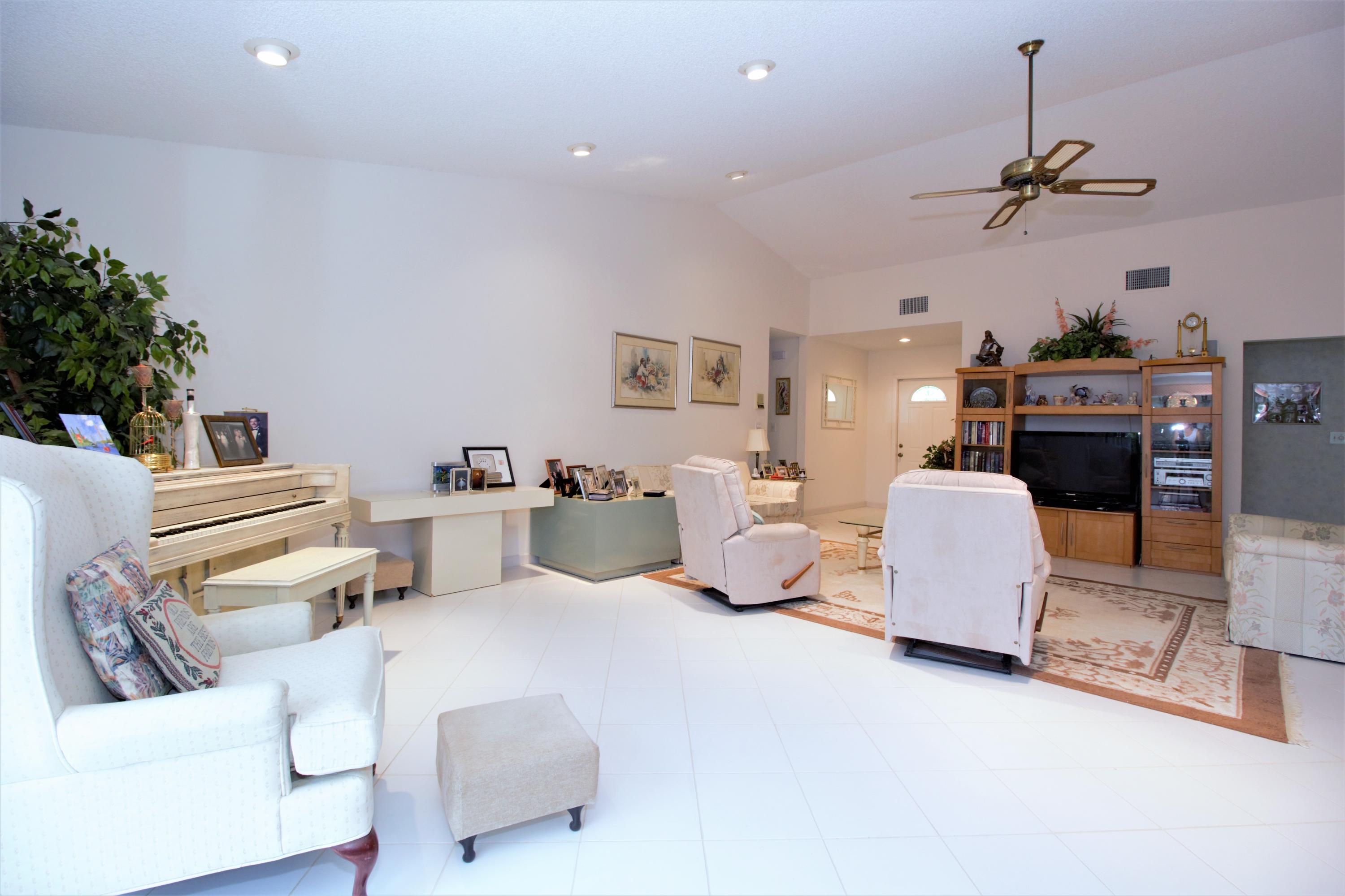 7751 Cloverfield Circle Boca Raton, FL 33433 - Photo 6 of 26 a living room with furniture and a chandelier