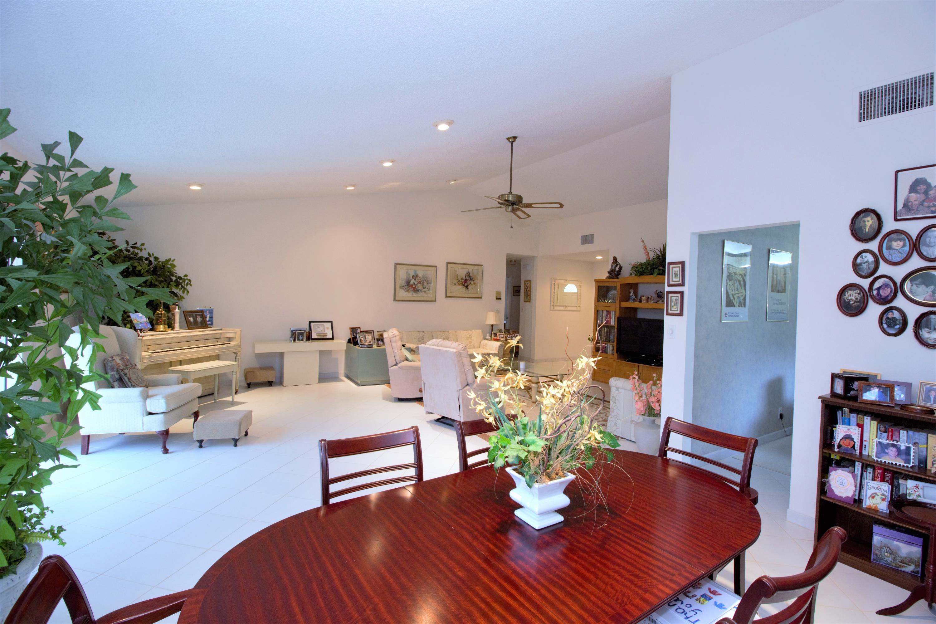 7751 Cloverfield Circle Boca Raton, FL 33433 - Photo 8 of 26 a living room with furniture kitchen view and a potted plant