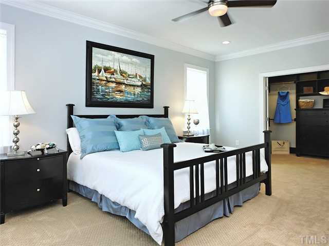 2305 Finley Ridge Lane Raleigh, NC 27615 - Photo 15 of 25 a bedroom with bed and a chandelier