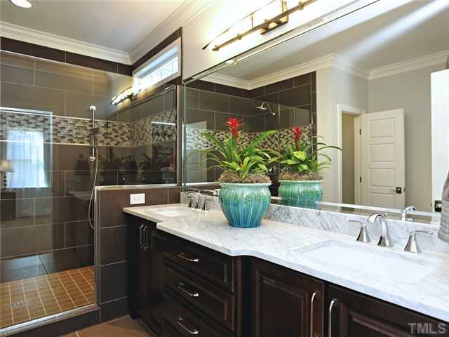 2305 Finley Ridge Lane Raleigh, NC 27615 - Photo 16 of 25 a bathroom with a granite countertop sink a mirror and a shower