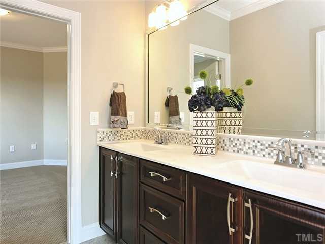 2305 Finley Ridge Lane Raleigh, NC 27615 - Photo 20 of 25 a bathroom with a sink and a mirror