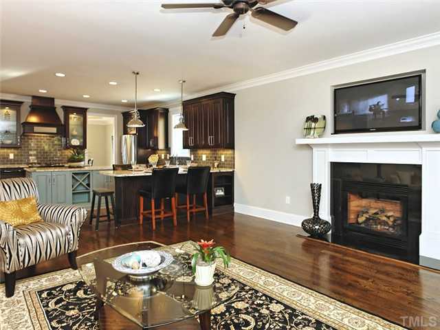 2305 Finley Ridge Lane Raleigh, NC 27615 - Photo 9 of 25 a living room with furniture a flat screen tv and a fireplace