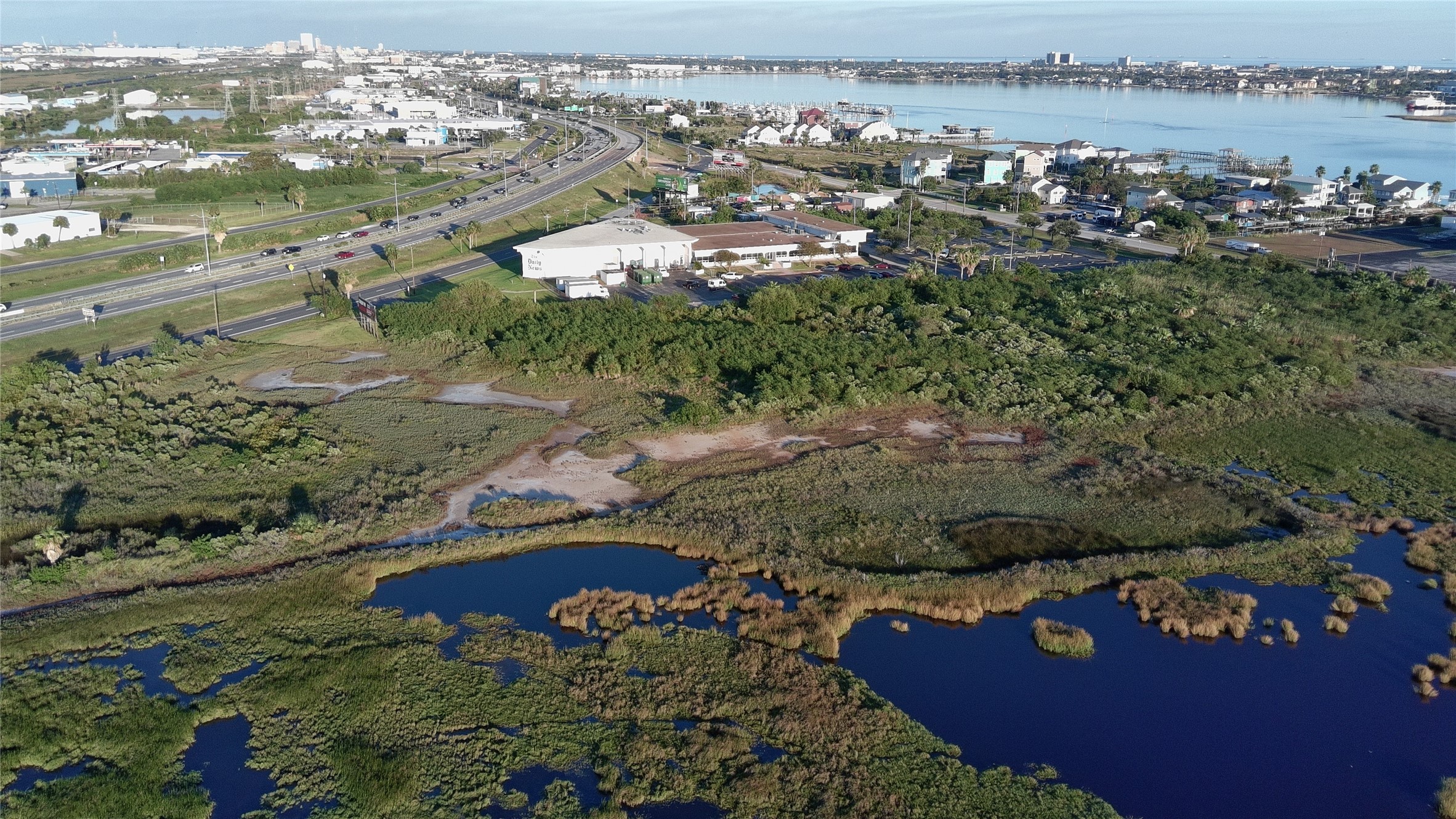 8509 Teichman Road Galveston, TX 77554 - Photo 2 of 16 a view of a lake with a city