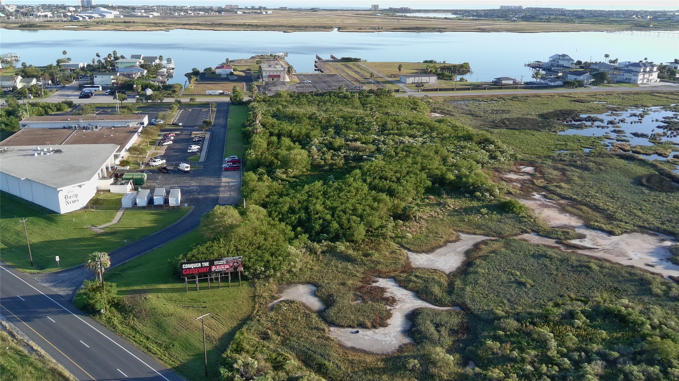 8509 Teichman Road Galveston, TX 77554 - Photo 6 of 16 a view of a lake with a big yard and large trees