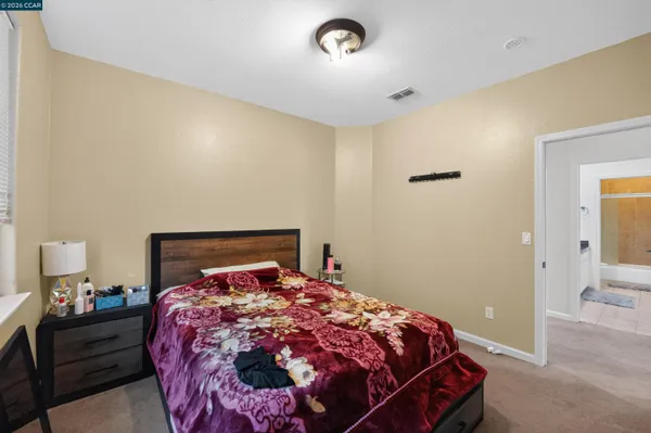 a bed sitting in a bedroom next to a window