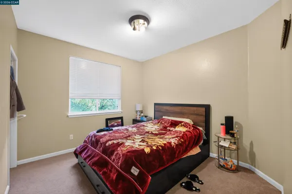 a bed sitting in a bedroom next to a window