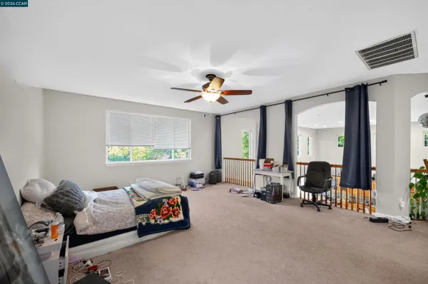 a living room with furniture and large windows
