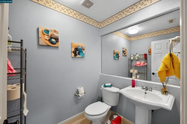 a bathroom with a sink mirror and toilet