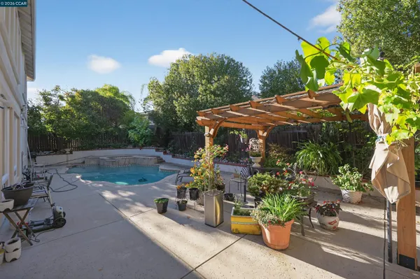 a view of a patio with table and chairs potted plants