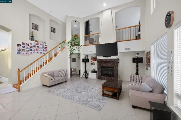 a living room with furniture and a chandelier