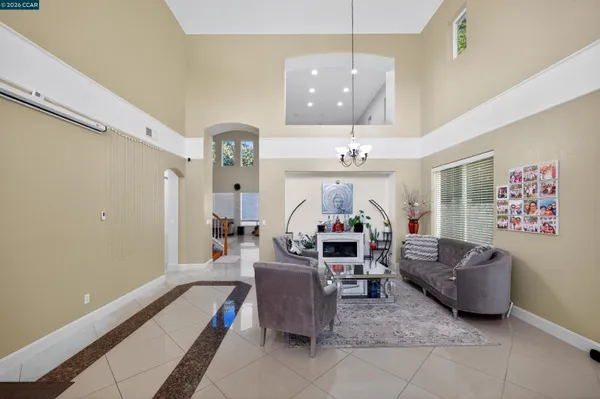 a living room with furniture chandelier and a chandelier