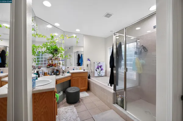 a room with lots of potted plants and glass doors