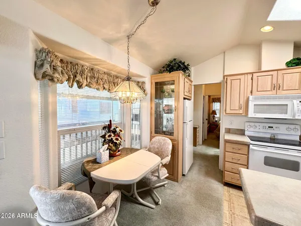 a dining room with furniture and window