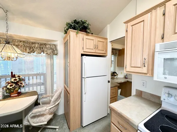 a kitchen with a refrigerator and a stove
