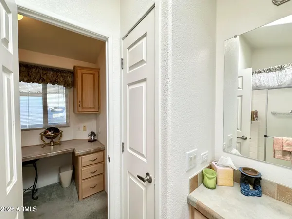 a bedroom with a bed and cabinets