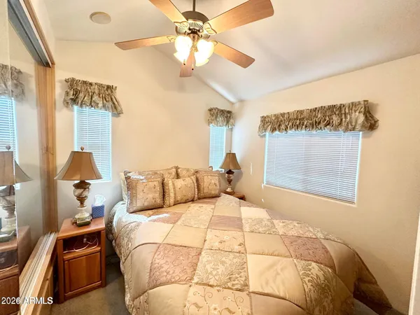 a bed room with a bed and a chandelier