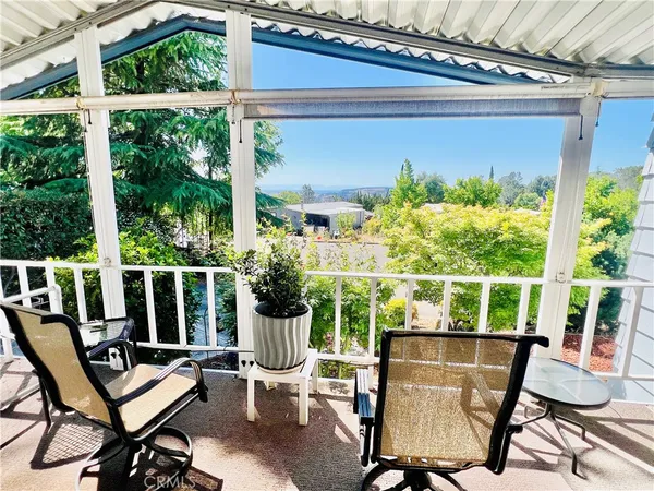 a view of a chairs and table in patio with a barbeque grill