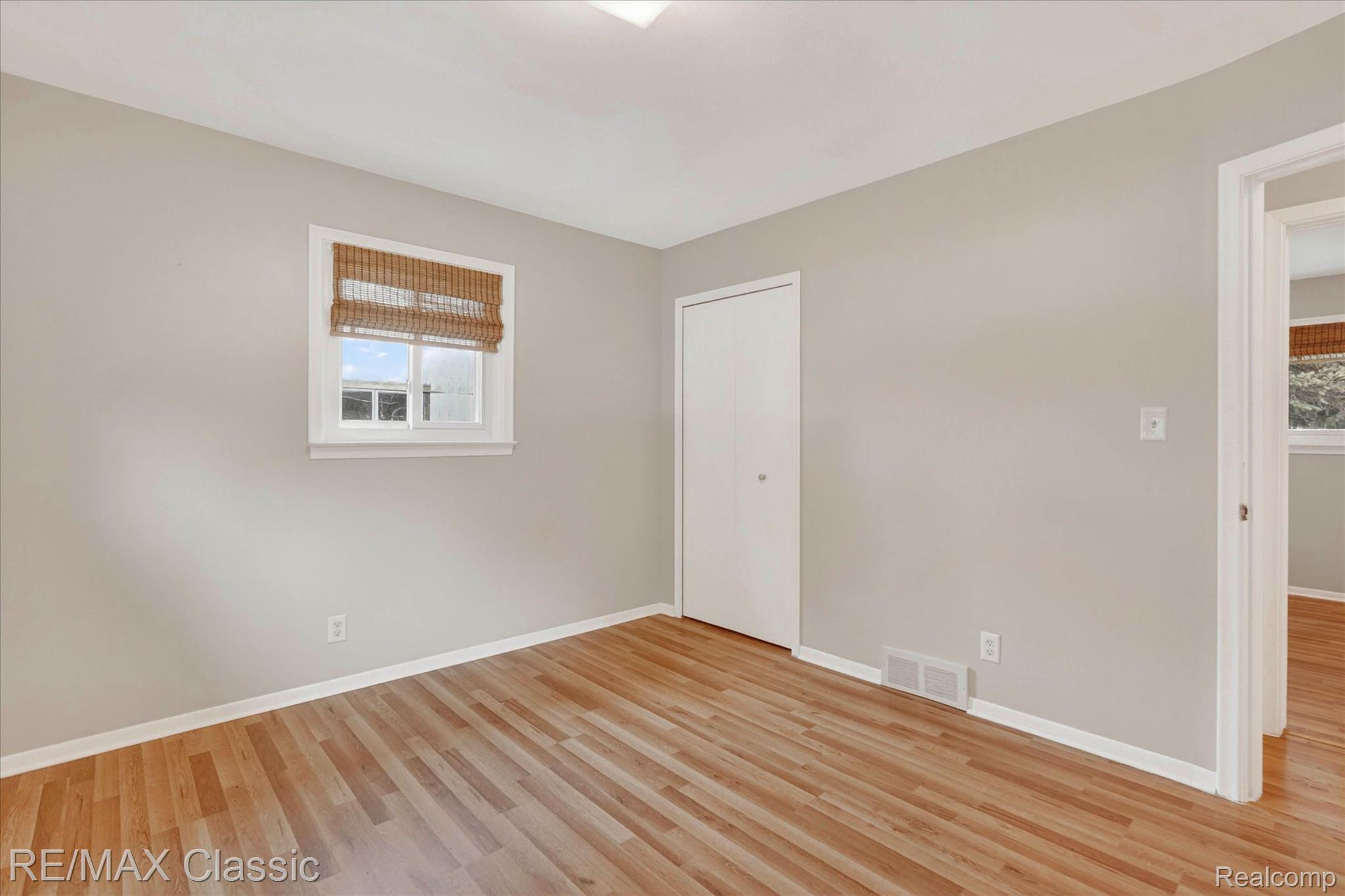 5060 Warmbriar Road White Lake, MI 48383 - Photo 9 of 34 Unfurnished bedroom featuring light wood finished floors and a closet