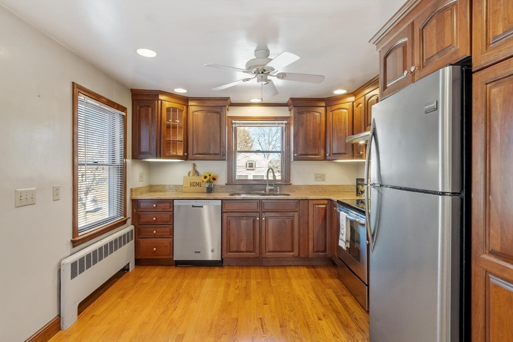 26 Lothrop Road Reading, MA 01867 - Photo 11 of 41 a kitchen with a refrigerator a sink and cabinets