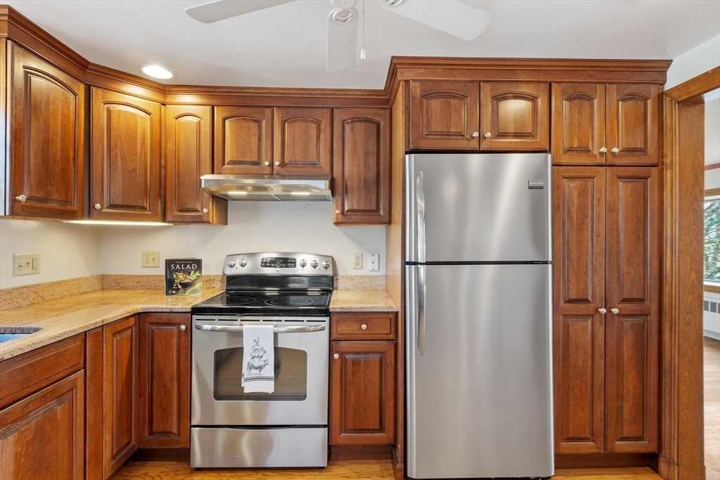 26 Lothrop Road Reading, MA 01867 - Photo 12 of 41 a kitchen with appliances and cabinets