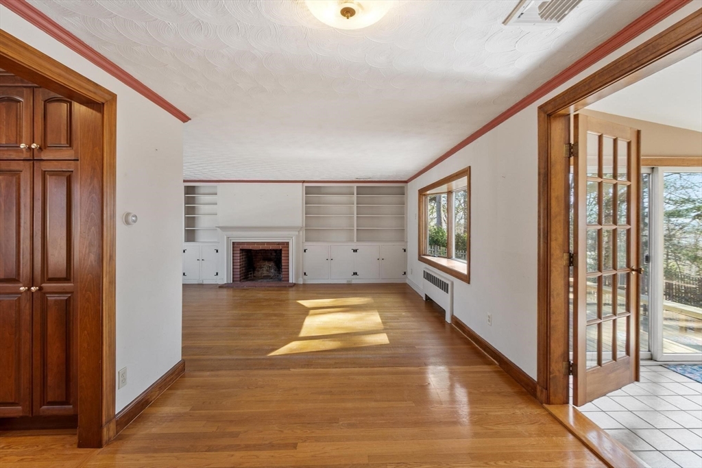 26 Lothrop Road Reading, MA 01867 - Photo 17 of 41 a view of an empty room with wooden floor and a window