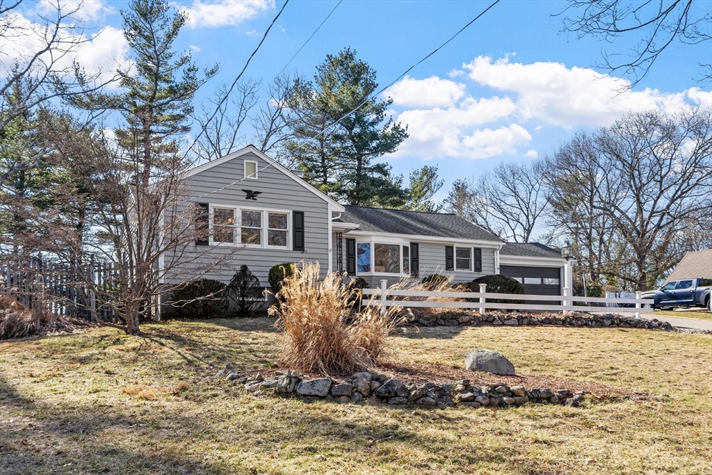 26 Lothrop Road Reading, MA 01867 - Photo 2 of 41 a front view of a house with a yard covered with snow in the background