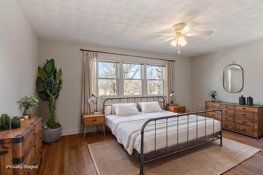 26 Lothrop Road Reading, MA 01867 - Photo 22 of 41 a bedroom with a large bed and a chandelier