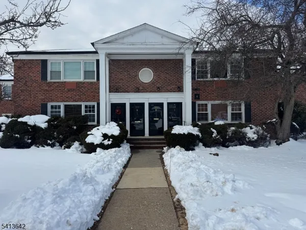 a view of a house with a yard covered in snow