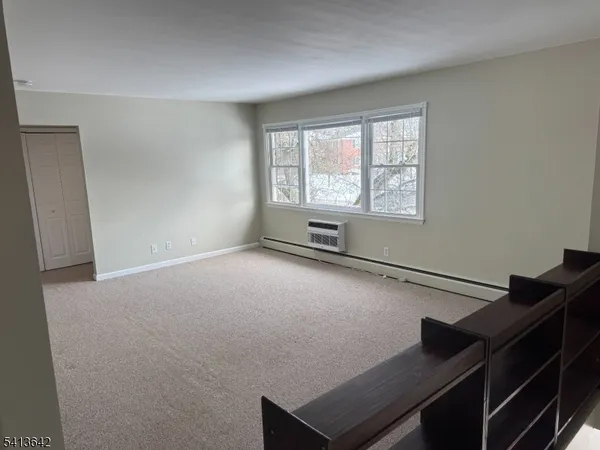a view of room with window and air conditioner duct