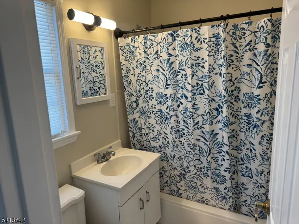 a bathroom with a sink toilet and mirror