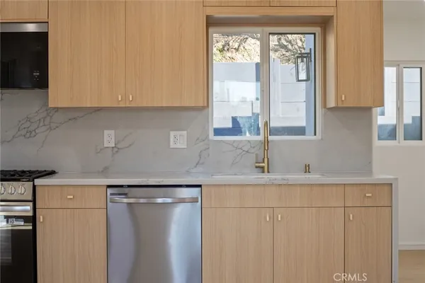 a kitchen with a sink and cabinets