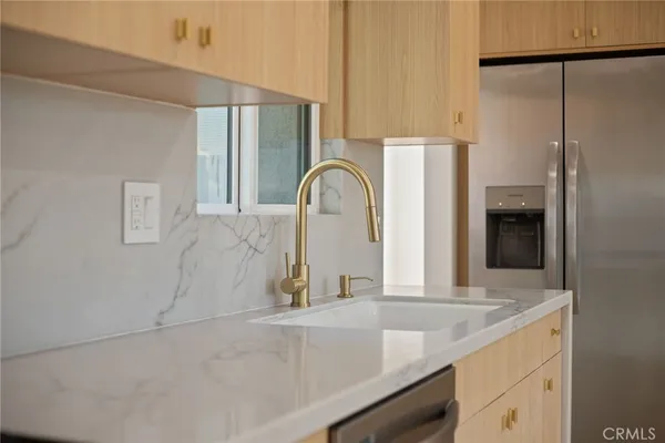 a view of a kitchen with a sink and a large window