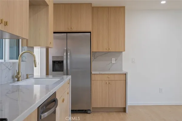 a kitchen with a refrigerator and a sink