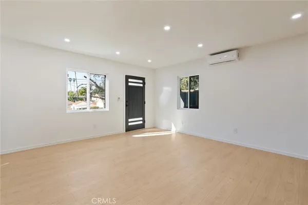 an empty room with windows and closet