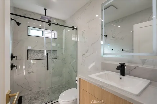 a bathroom with a sink toilet and shower