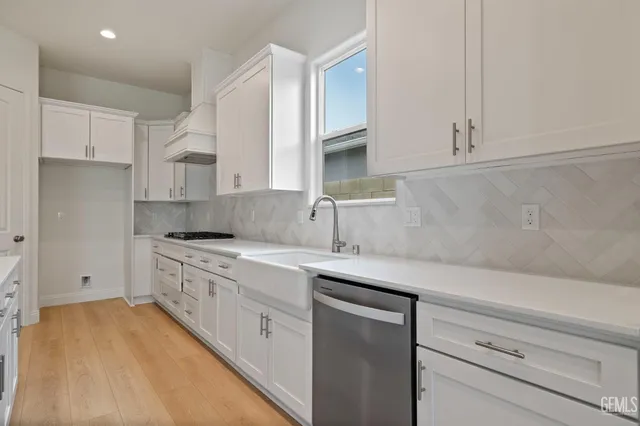a kitchen with a sink stove and cabinets