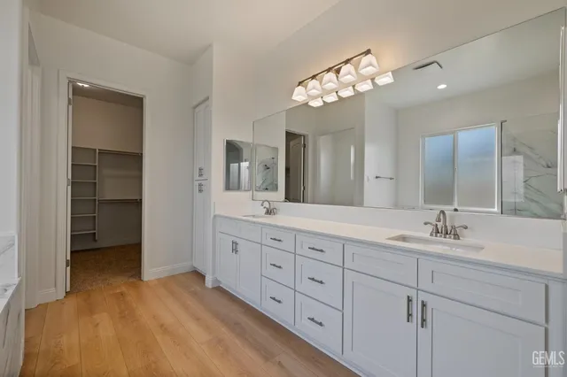 a spacious bathroom with double sink and a mirror