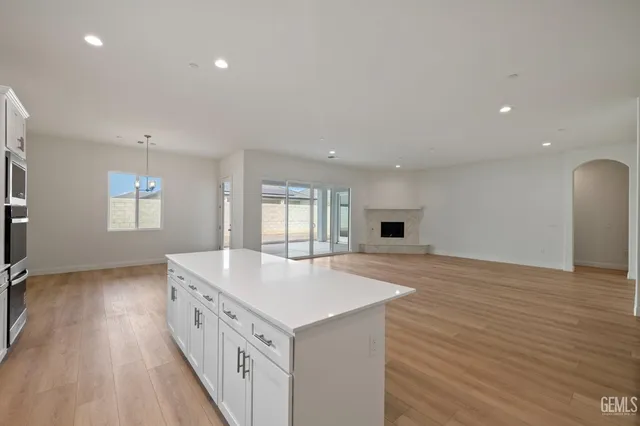 a kitchen with stainless steel appliances granite countertop a sink stove and wooden floor