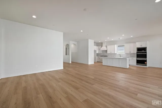 a view of kitchen empty room with wooden floor